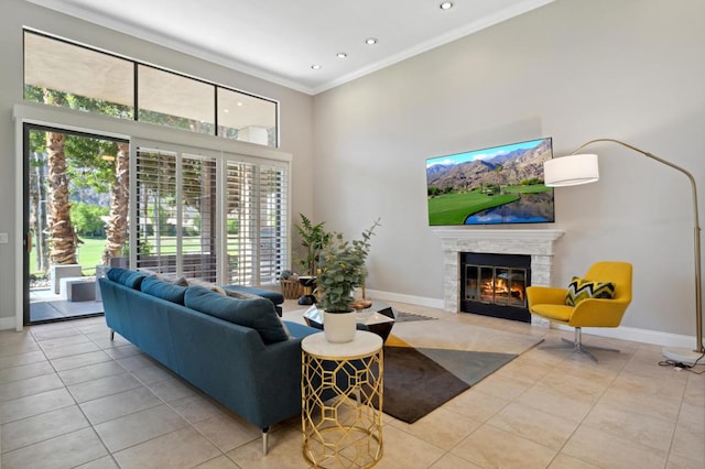 tiled living room featuring a healthy amount of sunlight, ornamental molding, and a high ceiling