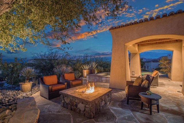 patio terrace at dusk with an outdoor fire pit