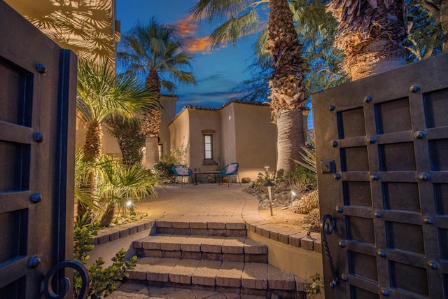 yard at dusk with a patio area