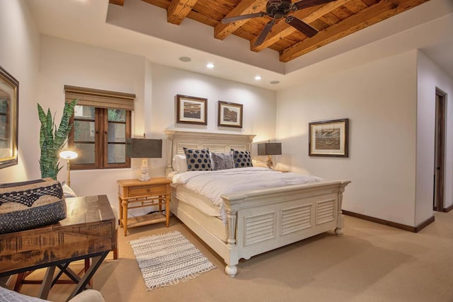 bedroom with beamed ceiling, light carpet, ceiling fan, and wood ceiling