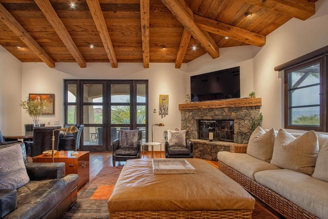 living room with french doors, hardwood / wood-style flooring, a stone fireplace, and wooden ceiling