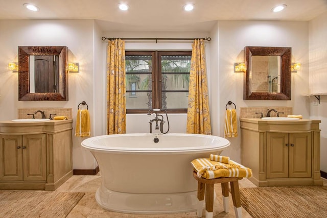 bathroom with a washtub and vanity