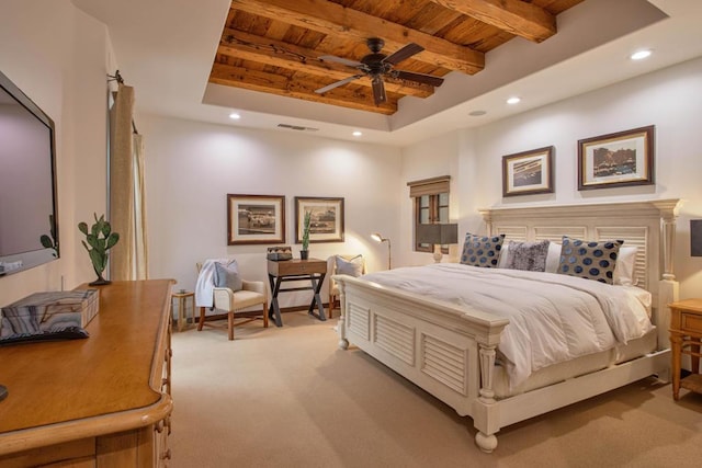 carpeted bedroom with a tray ceiling, ceiling fan, and wood ceiling