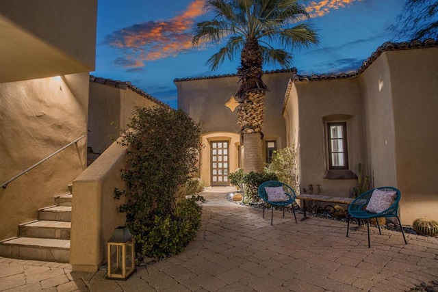 view of patio terrace at dusk