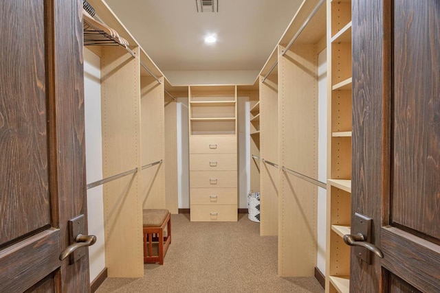 walk in closet with carpet flooring