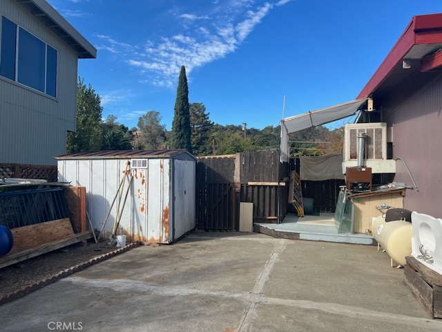 view of patio featuring a storage unit