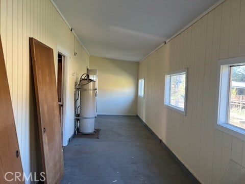 hallway featuring wooden walls