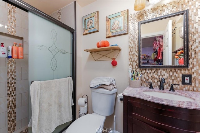 bathroom with walk in shower, decorative backsplash, vanity, and toilet