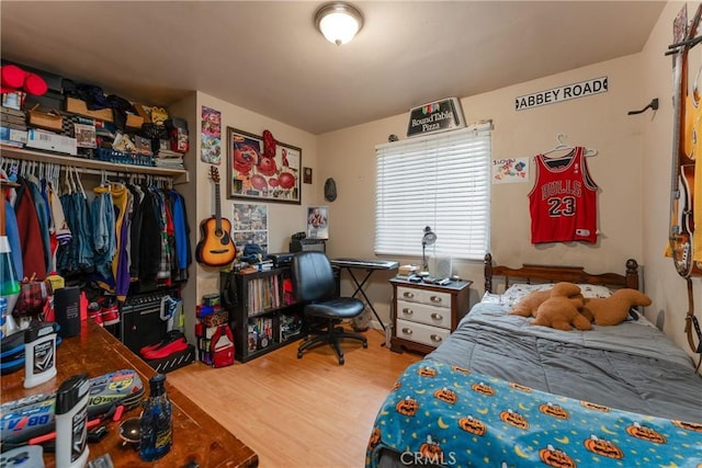 bedroom with a closet and hardwood / wood-style floors