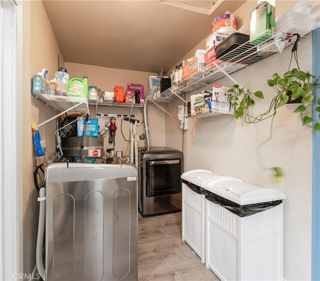 washroom featuring light hardwood / wood-style flooring and washer and dryer