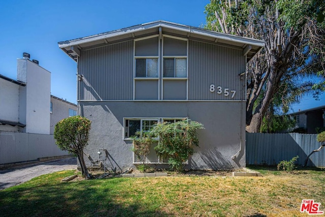 view of property exterior featuring a lawn