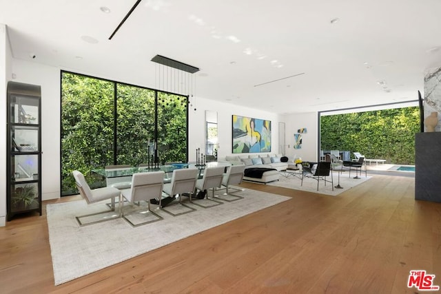 unfurnished dining area featuring light hardwood / wood-style flooring and floor to ceiling windows