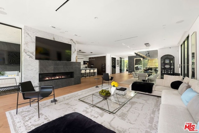 living room featuring a premium fireplace and hardwood / wood-style floors