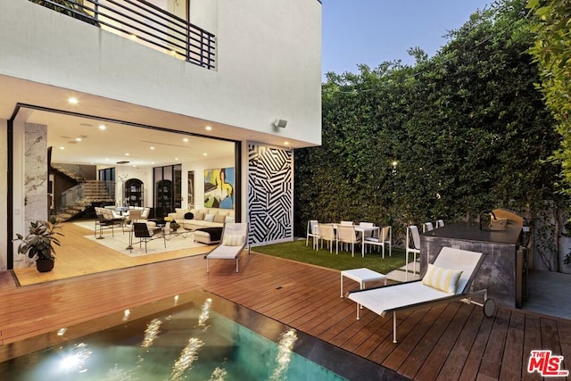 deck at dusk with an outdoor hangout area