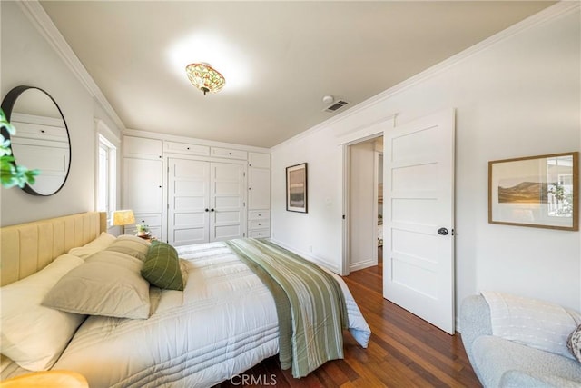 bedroom featuring ornamental molding, a closet, and dark hardwood / wood-style flooring