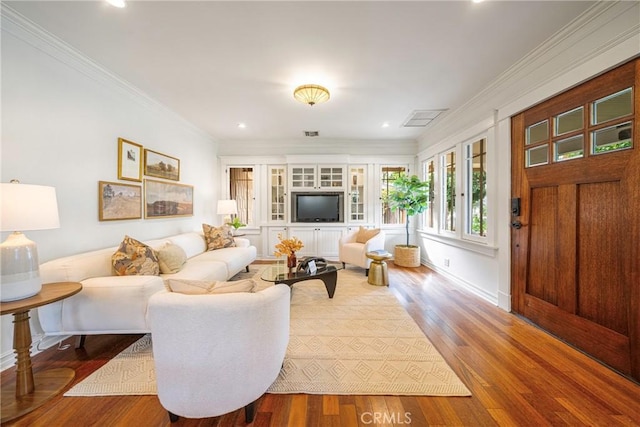 living room with ornamental molding and hardwood / wood-style floors