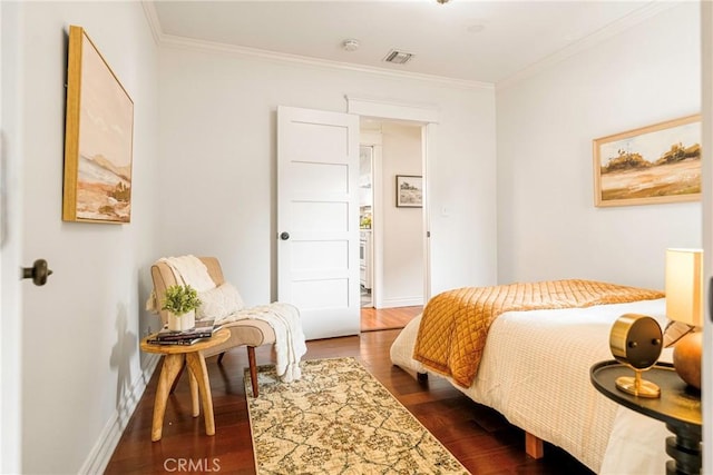 bedroom featuring crown molding and dark hardwood / wood-style floors