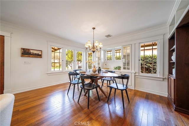 dining space featuring crown molding, a chandelier, and dark wood-type flooring