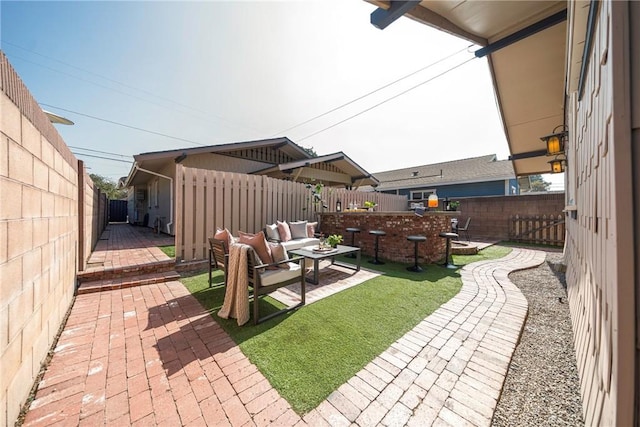 view of yard with outdoor lounge area and a patio