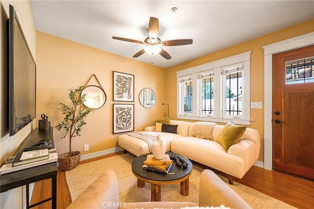 living room featuring light wood-type flooring and ceiling fan