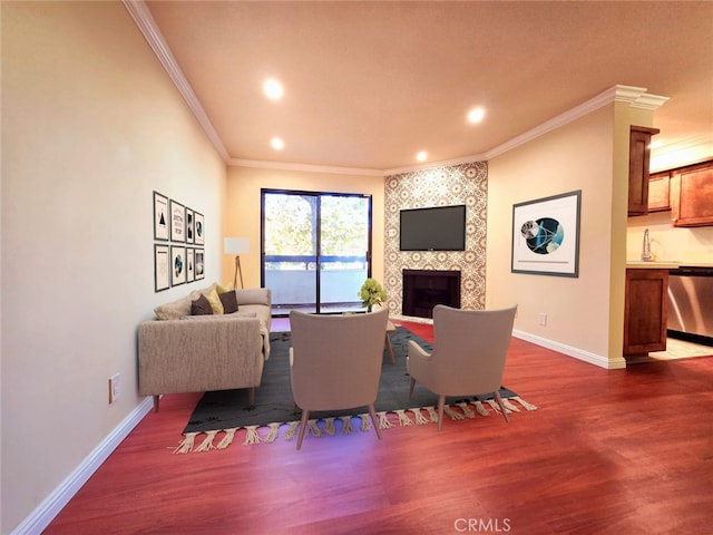 living room with dark hardwood / wood-style flooring, ornamental molding, and a tiled fireplace