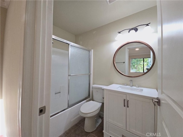 full bathroom with tile patterned floors, vanity, enclosed tub / shower combo, and toilet