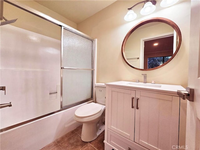 full bathroom with tile patterned floors, toilet, vanity, and combined bath / shower with glass door