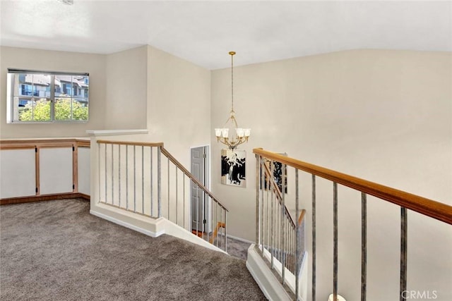 staircase with carpet and an inviting chandelier