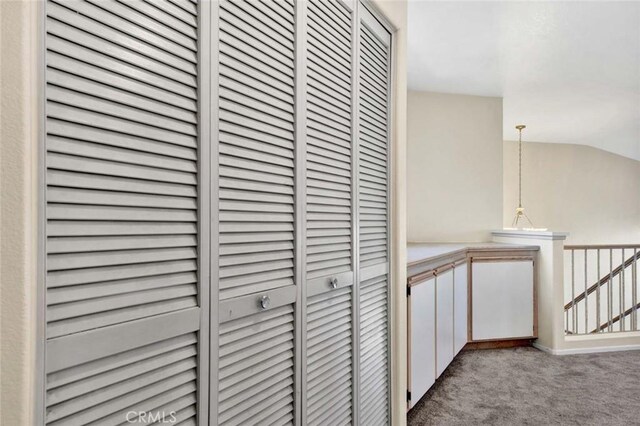 hallway with light colored carpet