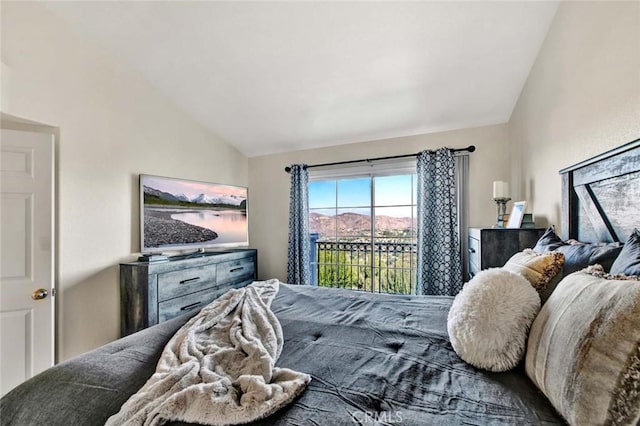 bedroom featuring lofted ceiling and access to outside