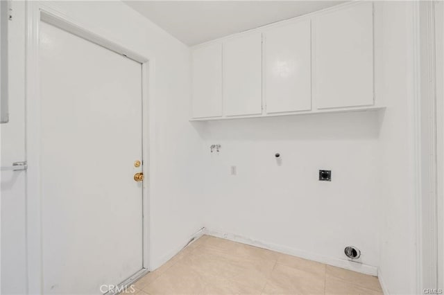 clothes washing area featuring hookup for a gas dryer, light tile patterned flooring, electric dryer hookup, and cabinets