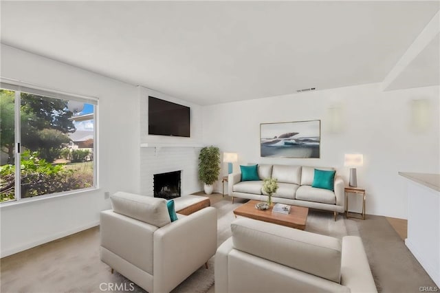 living room featuring light colored carpet and a brick fireplace