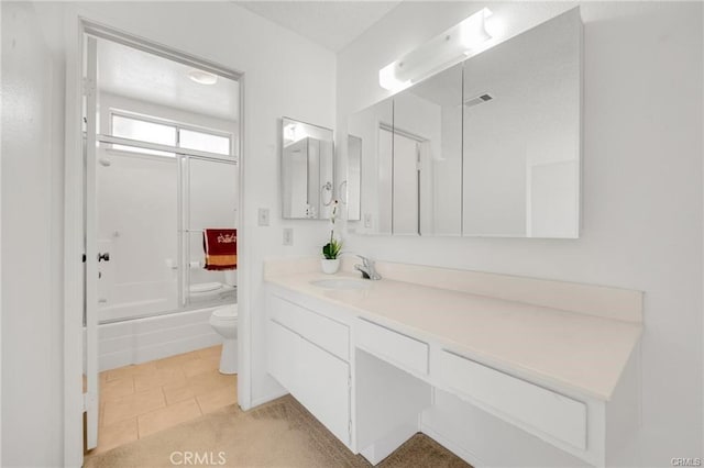 bathroom featuring shower / bath combination with glass door, tile patterned flooring, vanity, toilet, and visible vents