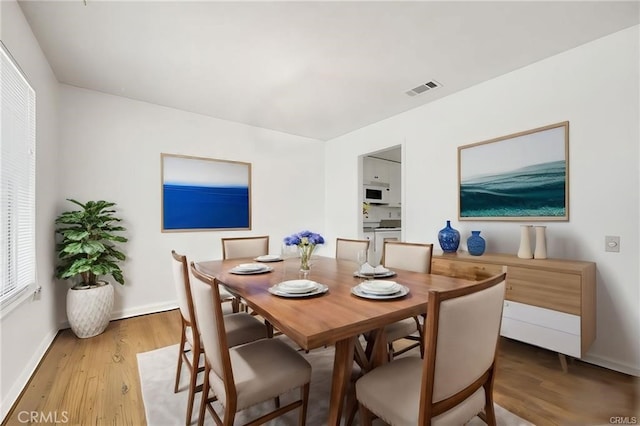 dining area with hardwood / wood-style floors