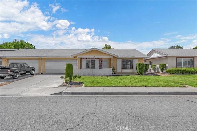 single story home featuring a front lawn and a garage