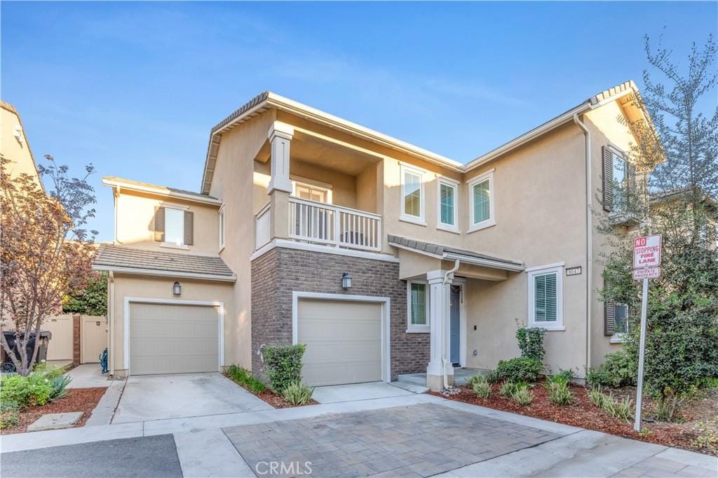 townhome / multi-family property featuring a garage and a balcony