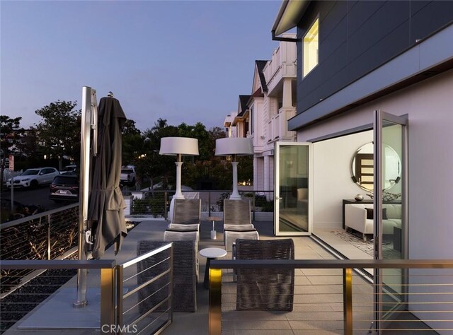 patio terrace at dusk with a balcony