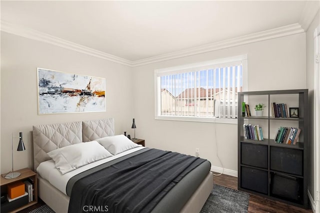 bedroom with crown molding and dark hardwood / wood-style flooring