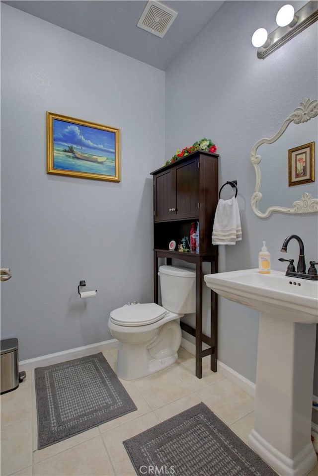 bathroom with tile patterned flooring and toilet