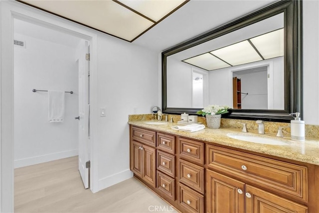 bathroom with vanity and hardwood / wood-style flooring