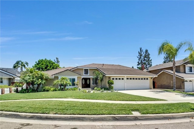 view of front facade with a front yard and a garage