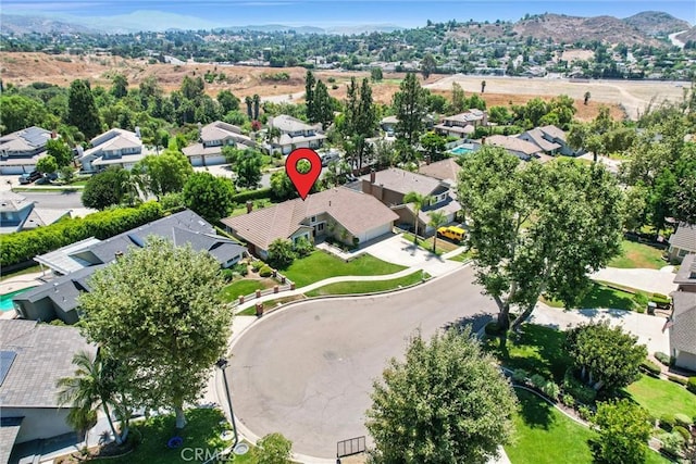 birds eye view of property with a mountain view