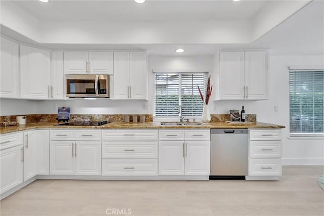 kitchen featuring white cabinets, sink, and appliances with stainless steel finishes