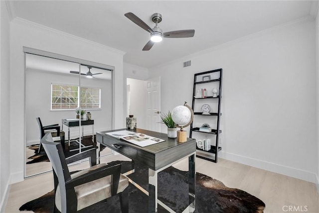 office space with light hardwood / wood-style flooring and ornamental molding