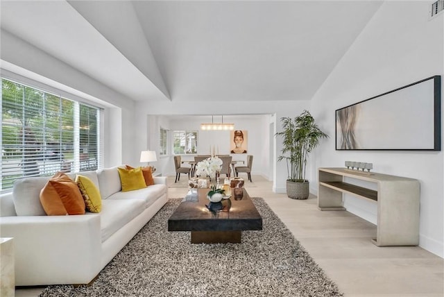 living room featuring light wood-type flooring and lofted ceiling