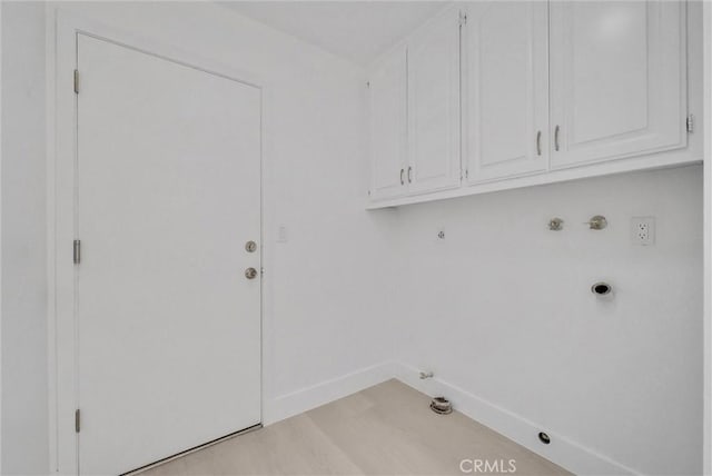 laundry room with cabinets, washer hookup, light wood-type flooring, electric dryer hookup, and hookup for a gas dryer