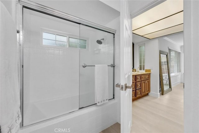 bathroom with hardwood / wood-style floors, vanity, and a shower with shower door