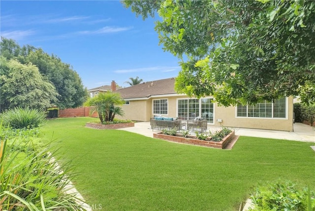 rear view of house featuring a lawn, an outdoor living space, and a patio