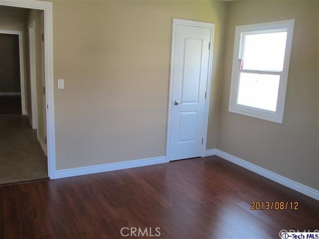 unfurnished room featuring dark hardwood / wood-style floors