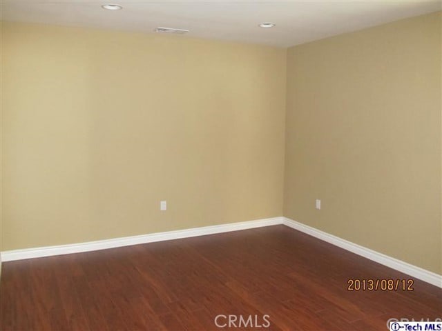 empty room with hardwood / wood-style floors